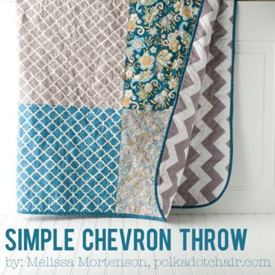 blue and gray quilt hanging on wall