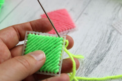 colorful yarn and plastic canvas ornament construction steps