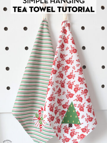 Two holiday tea towels on white table